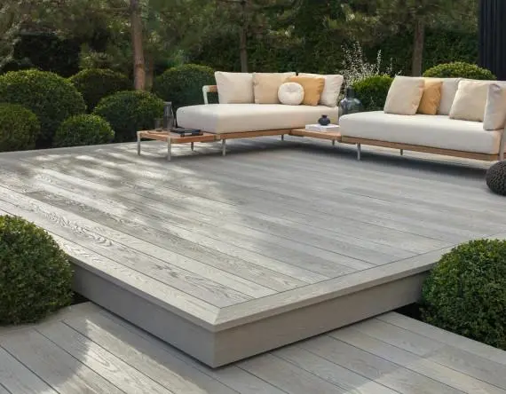 Domestic garden design with structured planting and paved outdoor living areas