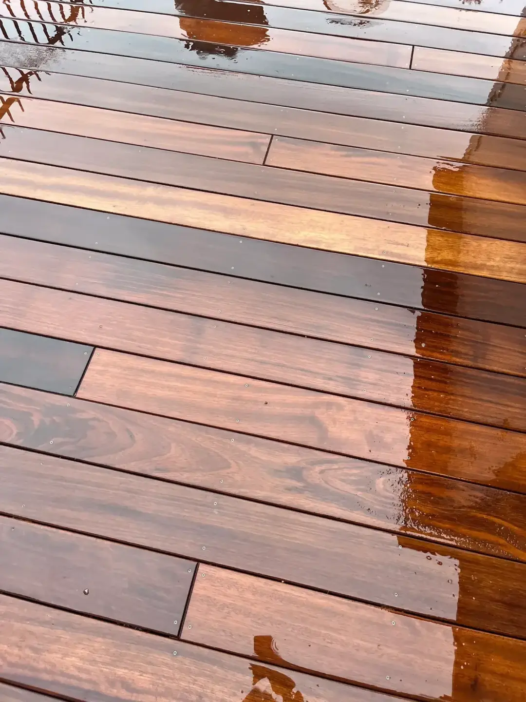 Decking repairs and maintenance with replaced timber boards and refinished surface