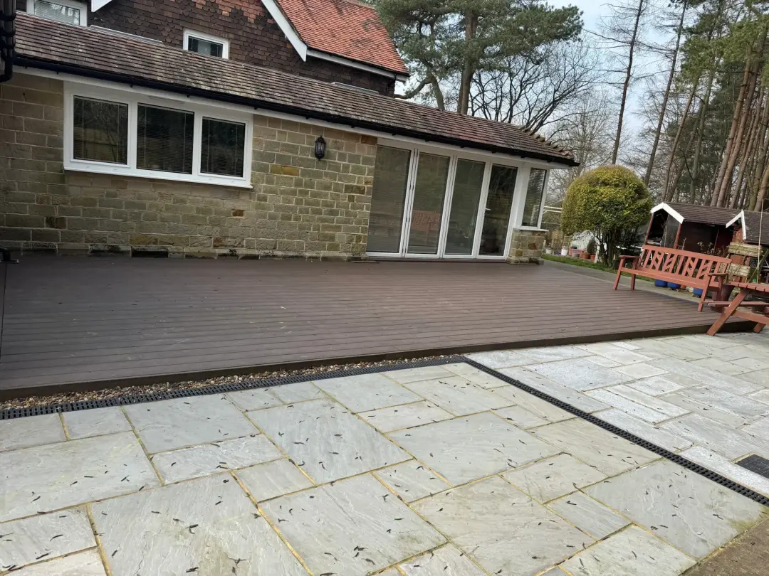 Completed composite deck adjoining a stone patio